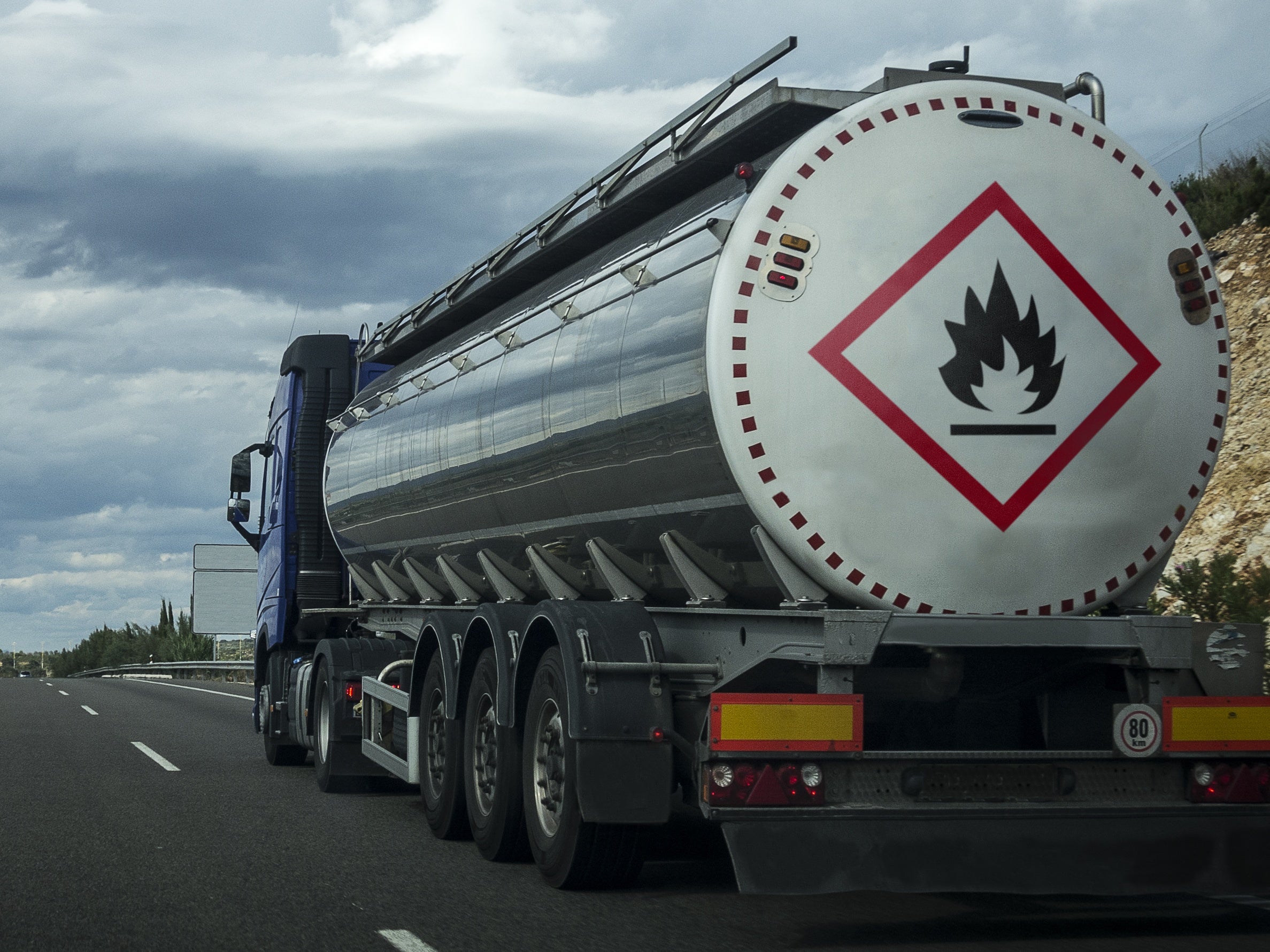 Radioactive material shipping container with hazard warning symbols